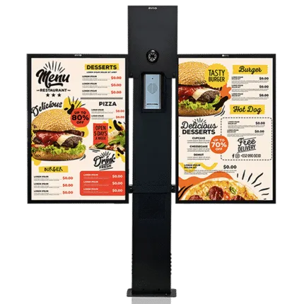 Avio intercom post with built-in camera and keypad flanked by two digital menu boards showing burger, pizza, and dessert options.