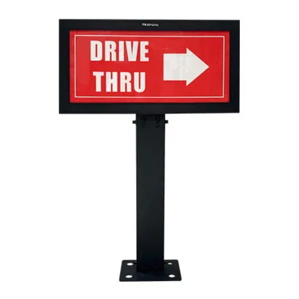 Front view of a black-framed "DRIVE THRU" directional sign with a right-pointing arrow, mounted on a metal post.