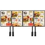 Four outdoor digital menu board posts side by side, each displaying a restaurant menu with burger, pizza, and dessert sections and pricing.