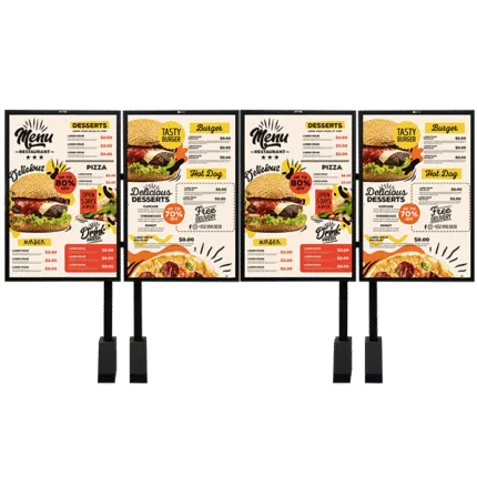 Four outdoor digital menu board posts side by side, each displaying a restaurant menu with burger, pizza, and dessert sections and pricing.