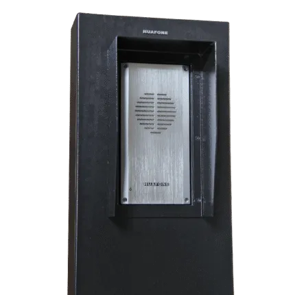 Close-up of a black Avio Technologies outdoor speaker post with a brushed metal intercom panel and mounting screws.